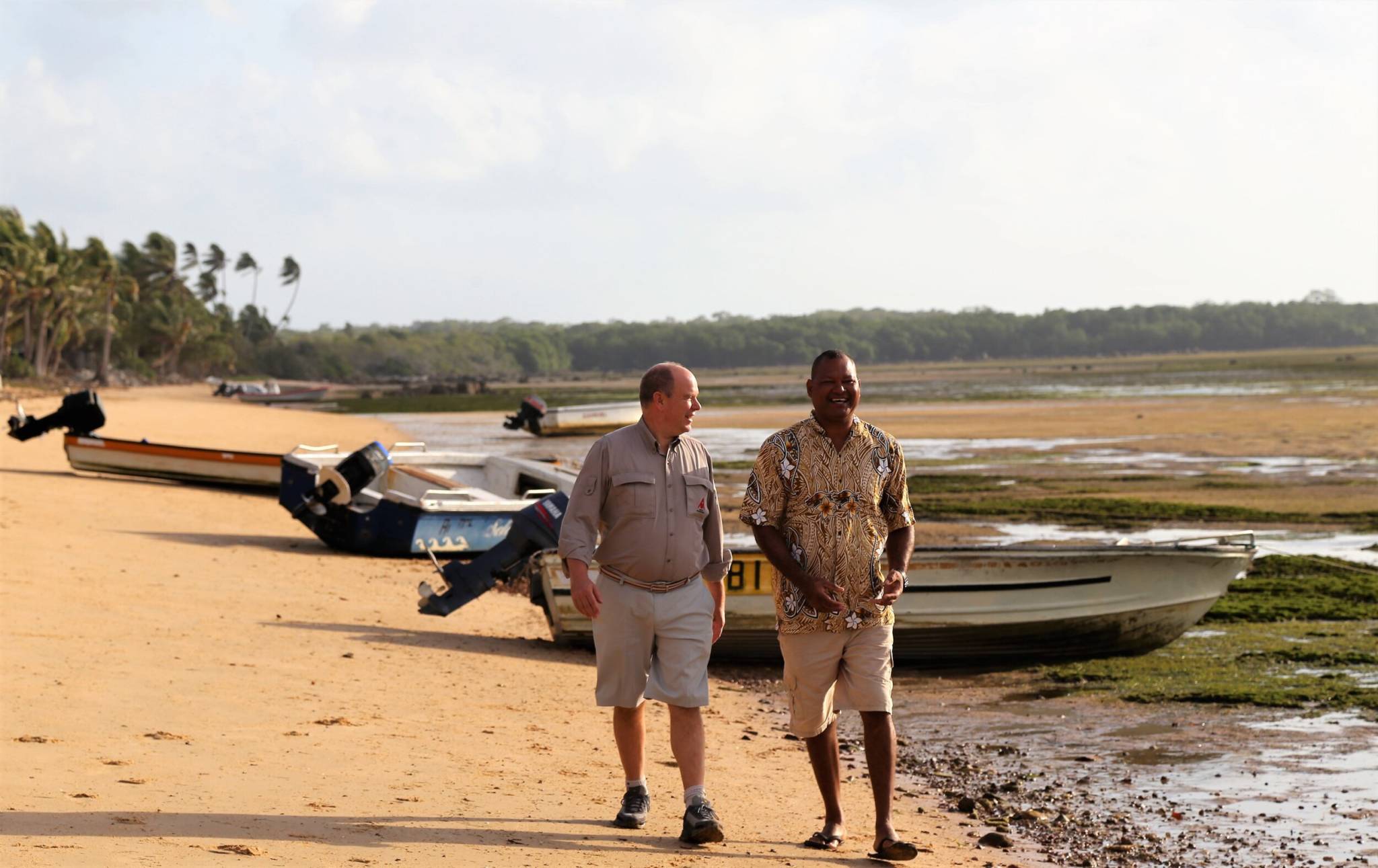 His Serene Highness Prince Albert II of Monaco and Alick Tipoti walk along the beach in film ALICK AND ALBERT