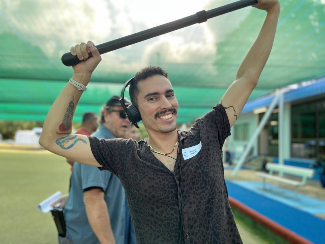 Film Intensive Script to Screen participant smiling and holding a boom over his head